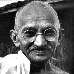 A smiling Gandhi looking straight at the camera