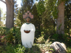 Statue of Latin American saint in a garden; Santa Fe